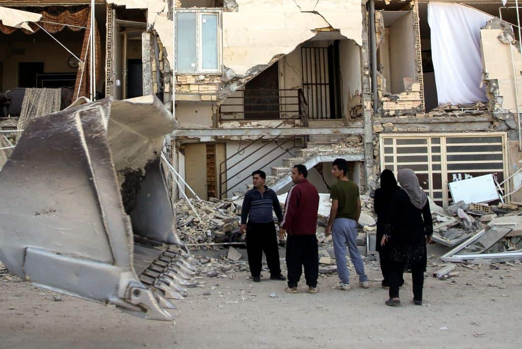People inspect the debris of buildings at Sarpol-e Zahab province of Kermanshah, Iran on November 13, 2017 following a 7.3 magnitude earthquake.