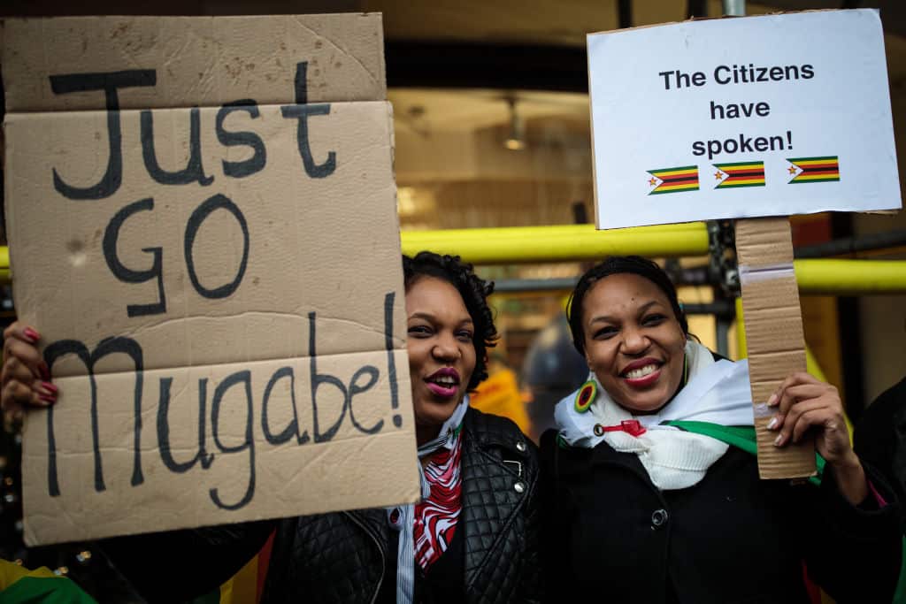 Protesters demonstrate outside the Embassy of Zimbabwe in London to call on the leader of the country Robert Mugabe to resign on November 18, 2017 in London, England. 93-year-old Mr Mugabe has been under house arrest following a military takeover.