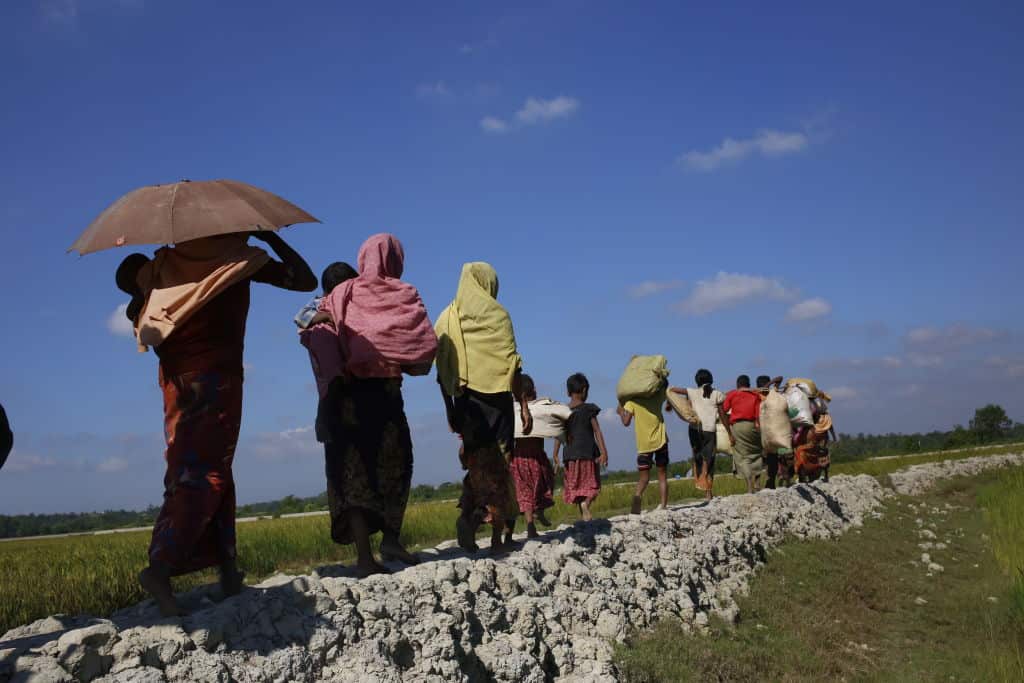 Rohingya refugee walks toward camp after crossing the