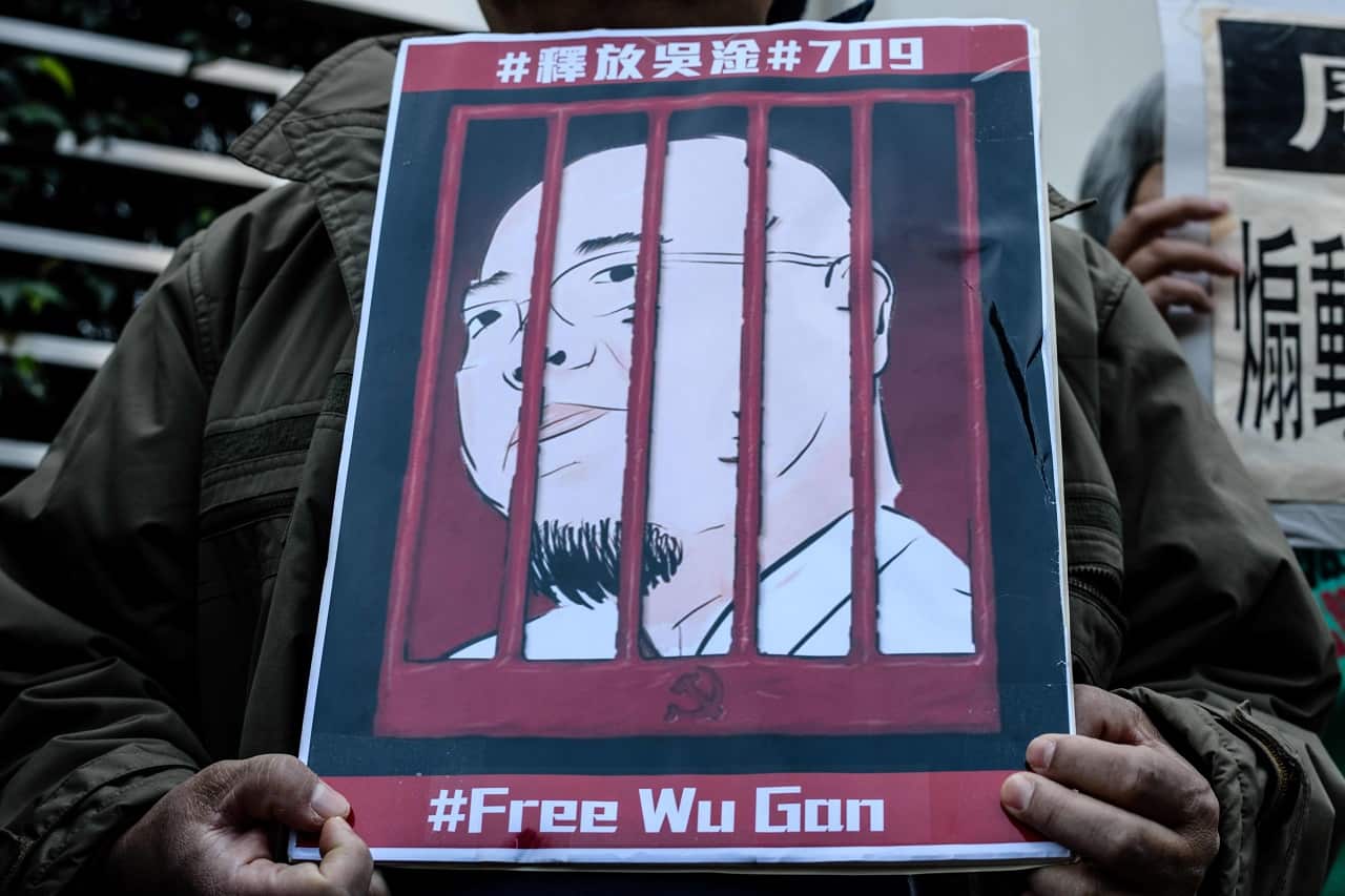 An activist holds a poster depicting the jailed Chinese activist Wu Gan in Hong Kong.