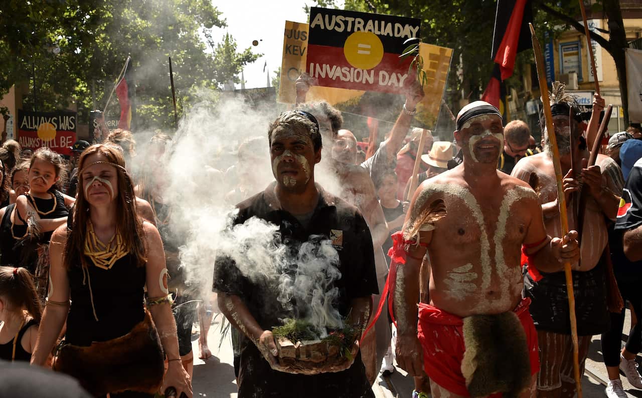 People take part in an "Invasion Day" rally on Australia Day in Melbourne on January 26, 2018.