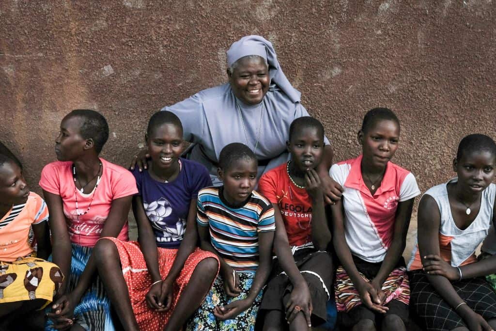 Magdalene Nantongo (C), head teacher of Kalas Girl's primary school, which hosts escaped girls from female genital mutilation (FGM) and child marriage.