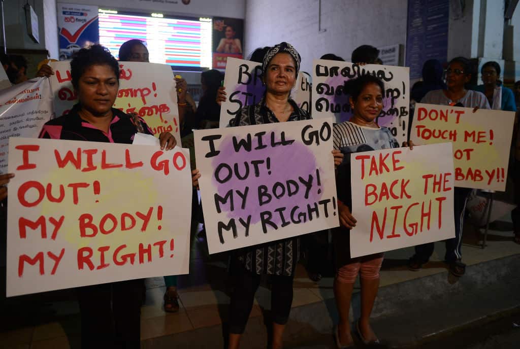 Women carry banners during a "Safe Sights, Safe Streets and Safe Homes for Women" evening demonstration in Colombo, Sri Lanka.