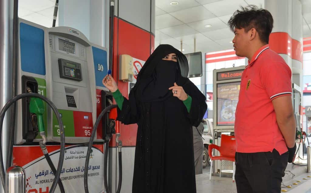 Saudi gas station supervisor Mervat Bukhari talking to a worker at her workplace in Khobar.