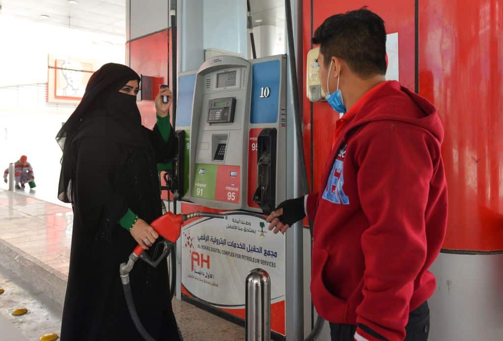 Saudi gas station supervisor Mervat Bukhari (L) standing near a worker at her workplace in Khobar.