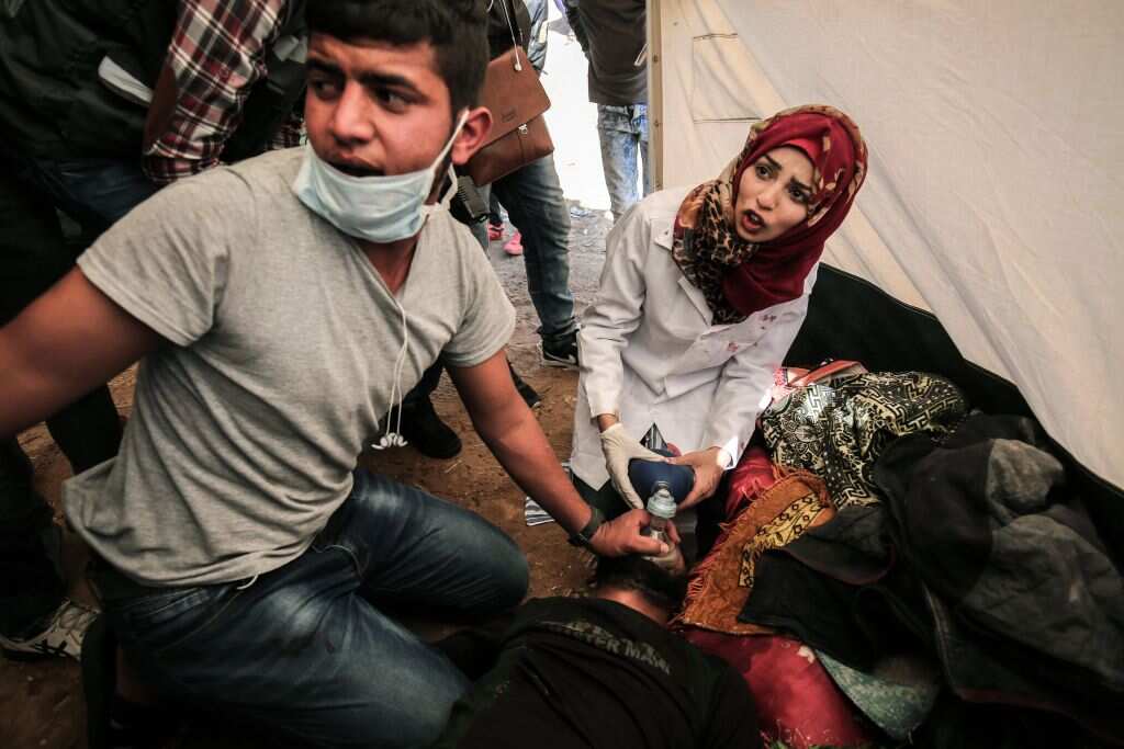 Razan al-Najjar (R), with a colleague at an emergency medical tent near the border with Israel, east of Khan Yunis, in the southern Gaza Strip, on April 1