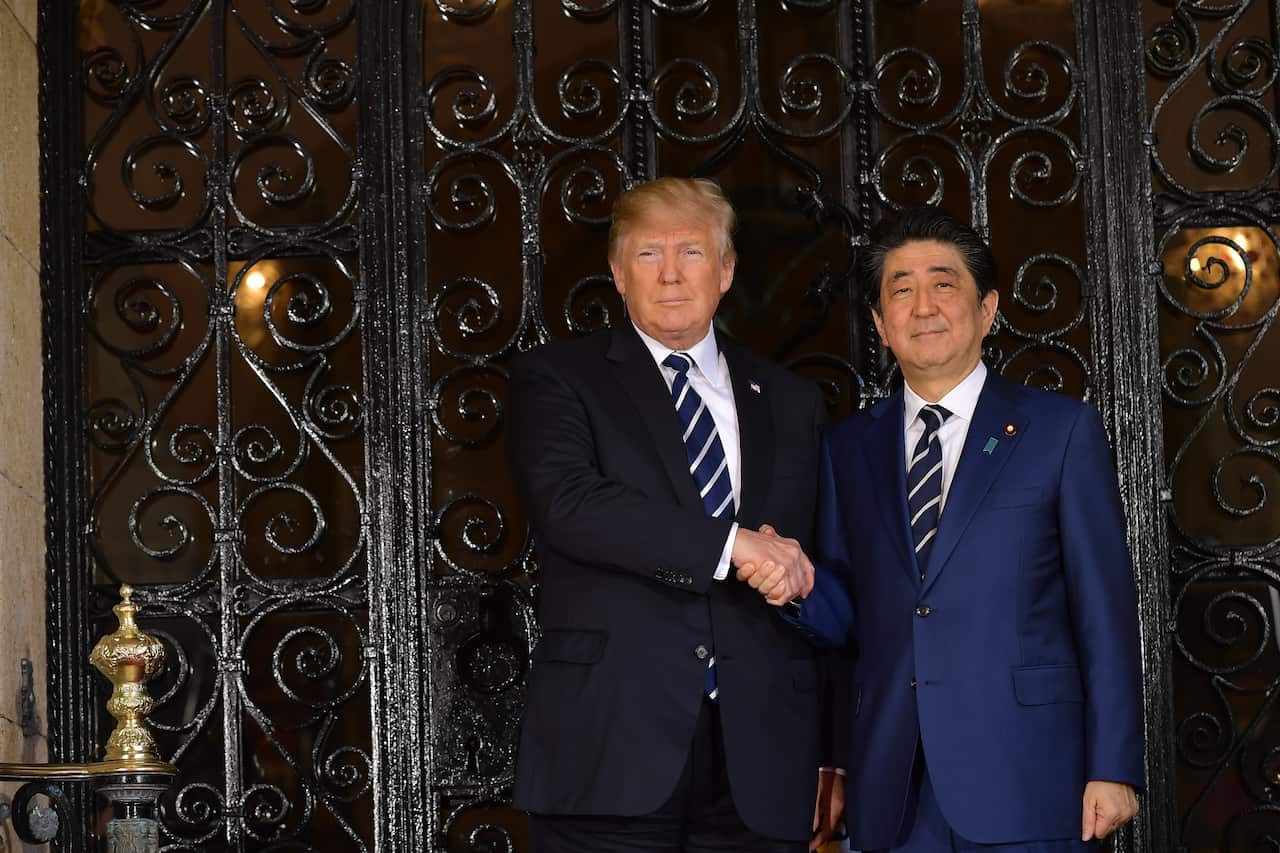 US President Donald Trump greets Japanese Prime Minister Shinzo Abe as he arrives for talks at Trump's Mar-a-Lago resort in Palm Beach, Florida, on April 17, 2018. / AFP PHOTO / MANDEL NGAN        (Photo credit should read MANDEL NGAN/AFP/Getty Images)
