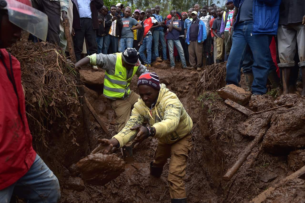 Villagers dig through mud as they attempt to find survivors of flash flooding in Kenya.