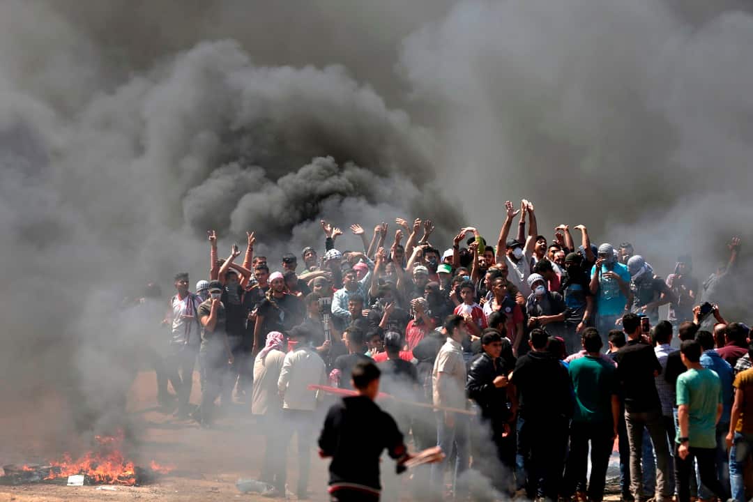 Palestinian demonstrators burn tyres near the Gaza-Israel border.