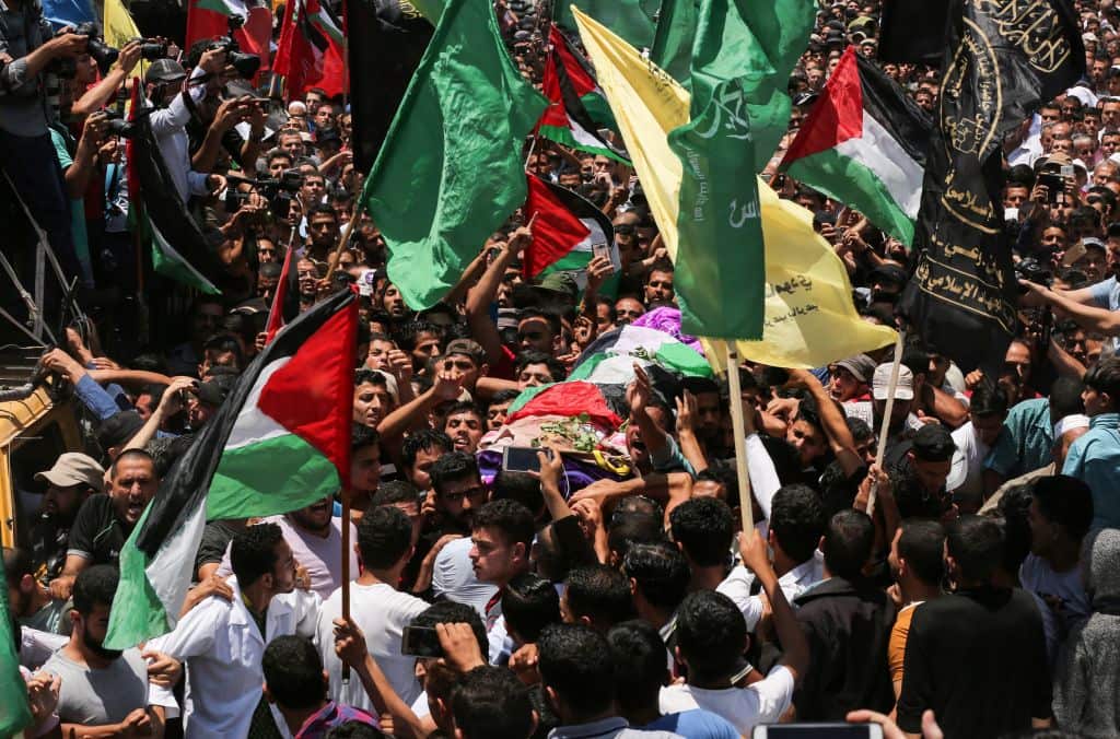 Palestinian mourners carry the body of Razan al-Najjar during her funeral 