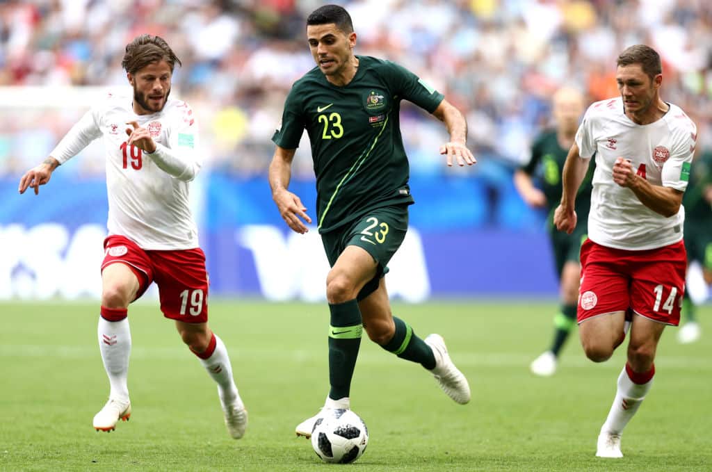 Tom Rogic of Australia runs with the ball under pressure from Lasse Schone of Denmark during the 2018 FIFA World Cup Russia.