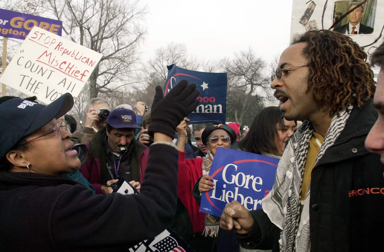 Tempers flare as George Bush and Al Gore protesters confront each other in front of the Supreme Court amid an appeal of the Florida recount in 2000.