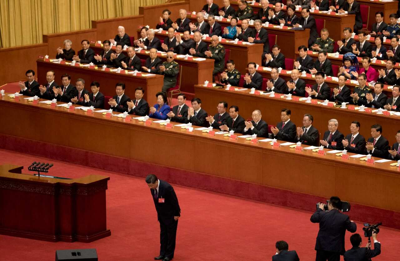 Chinese President Xi Jinping bows before delivering a speech at the opening ceremony of the 19th Party Congress 