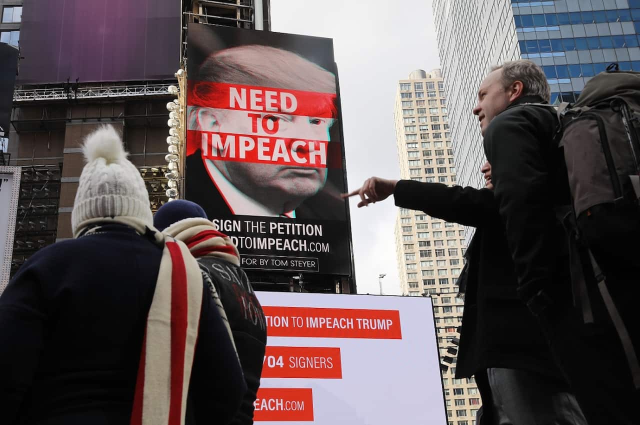 A billboard in Times Square, funded by Philanthropist Tom Steyer, calls for the impeachment of President Donald Trump (Getty)