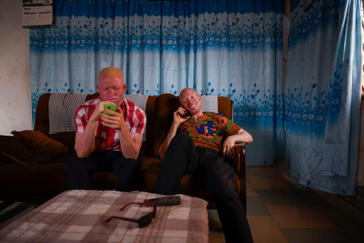 Richard Kabu and Kwame Andrews Daklo sit in a living room in Ashaiman, Ghana.