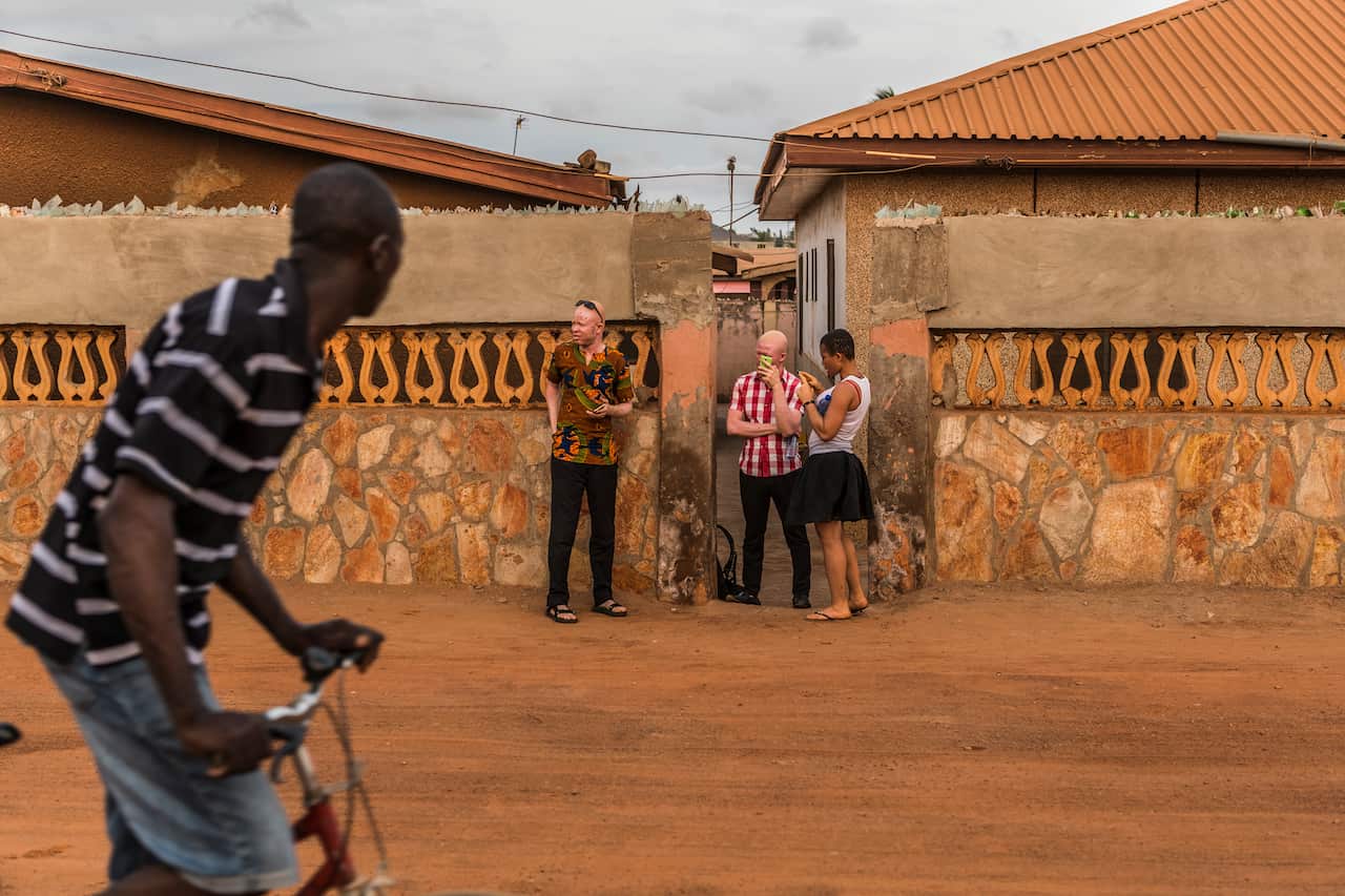 From left, Kwame Andrews Daklo, Richard Kabu and Beatrice Adjei, three close friends who met during an albinism advocacy workshop, wait for a taxi in Ashaiman, Ghana.