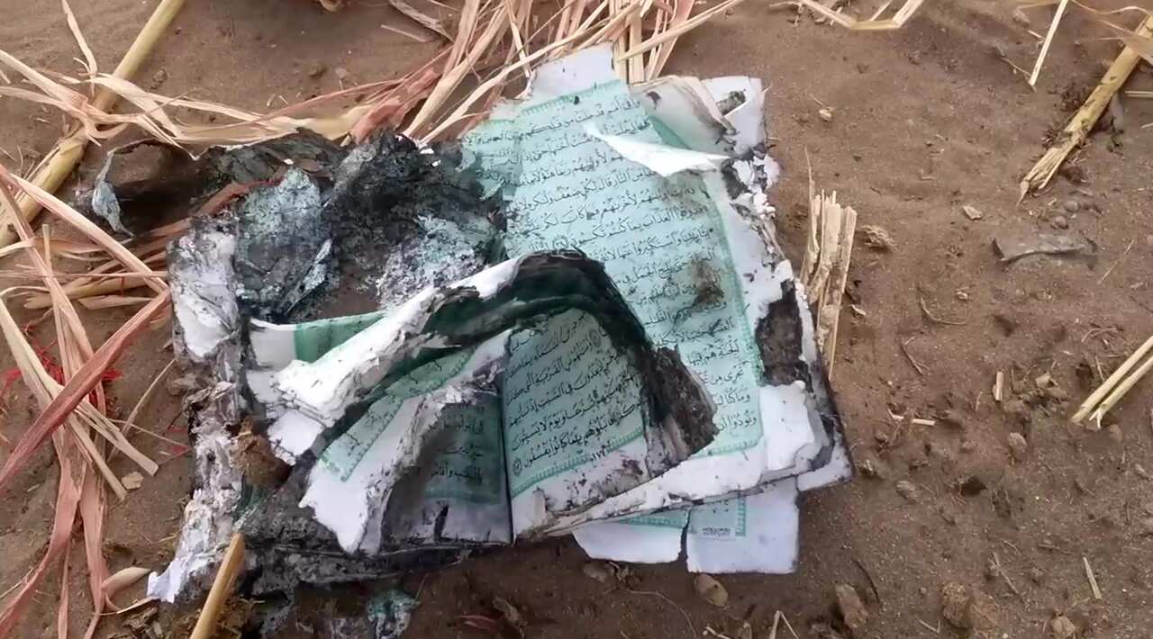 A frame grab made from a handout video made available by the Houthi Movement on 24 August 2018 shows burnt pages of a book at the scene of the alleged strike.