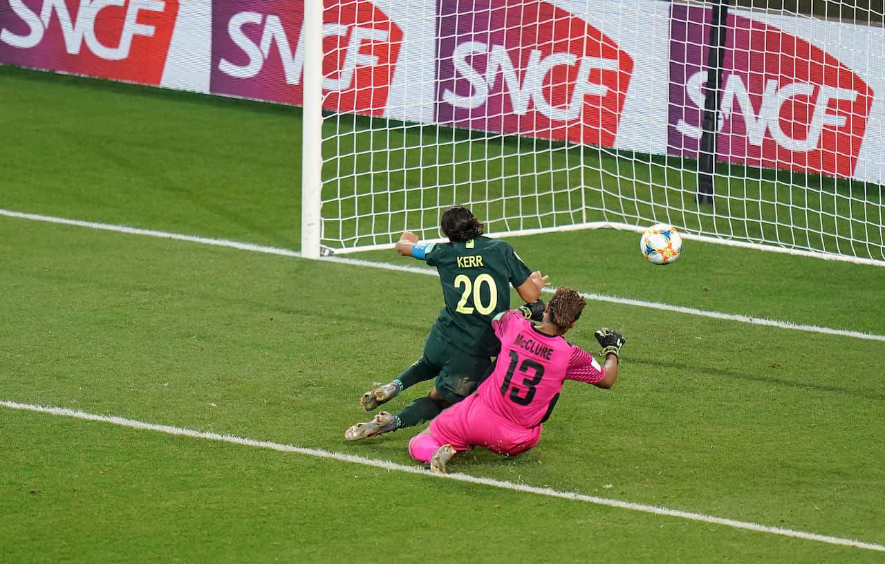 Australia's Sam Kerr (left) scores her side's fourth goal of the game.