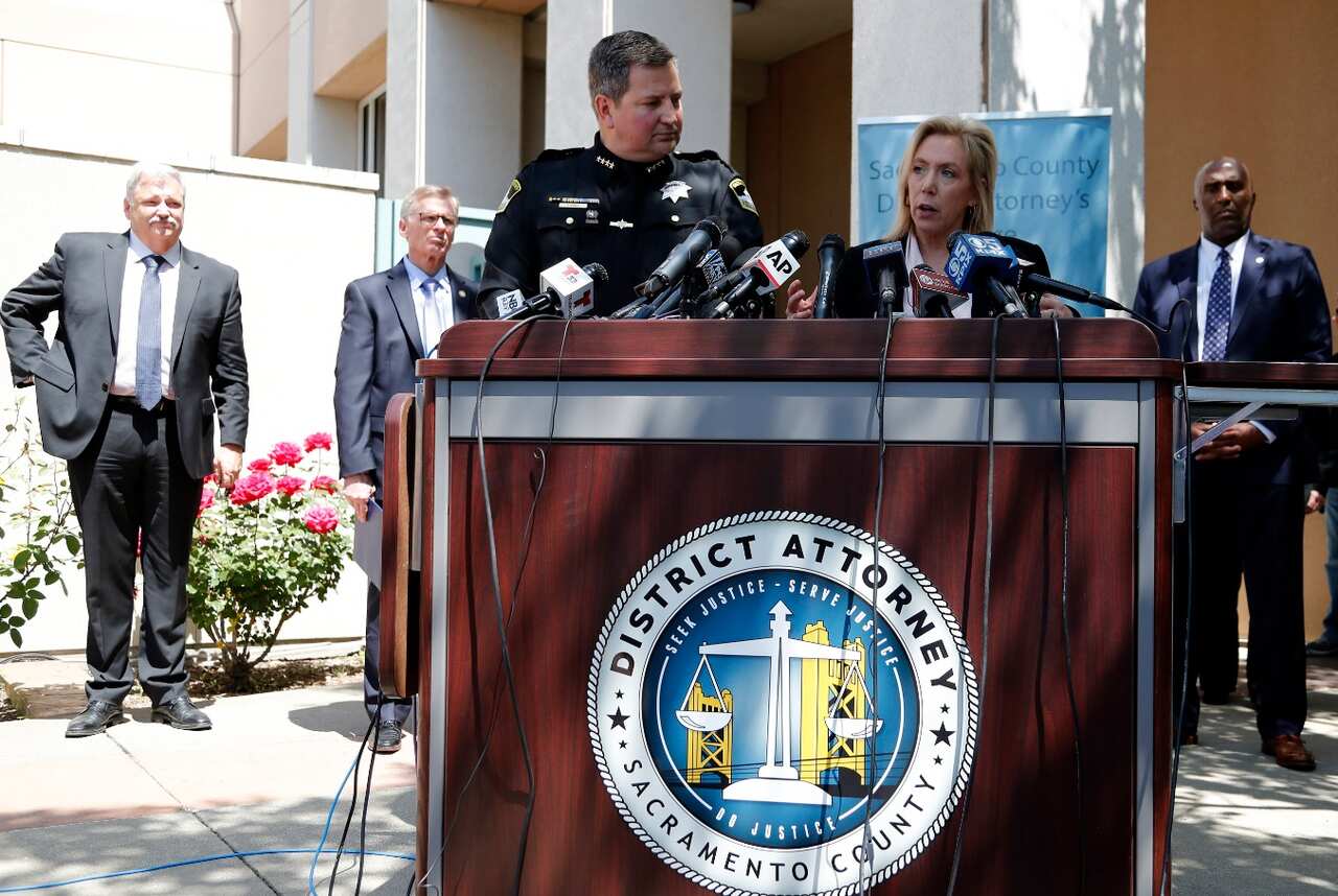 Sacramento District Attorney Anne Marie Schubert (2-R) responds to media questions as Sacramento County Sheriff Scott Jones (C) listens