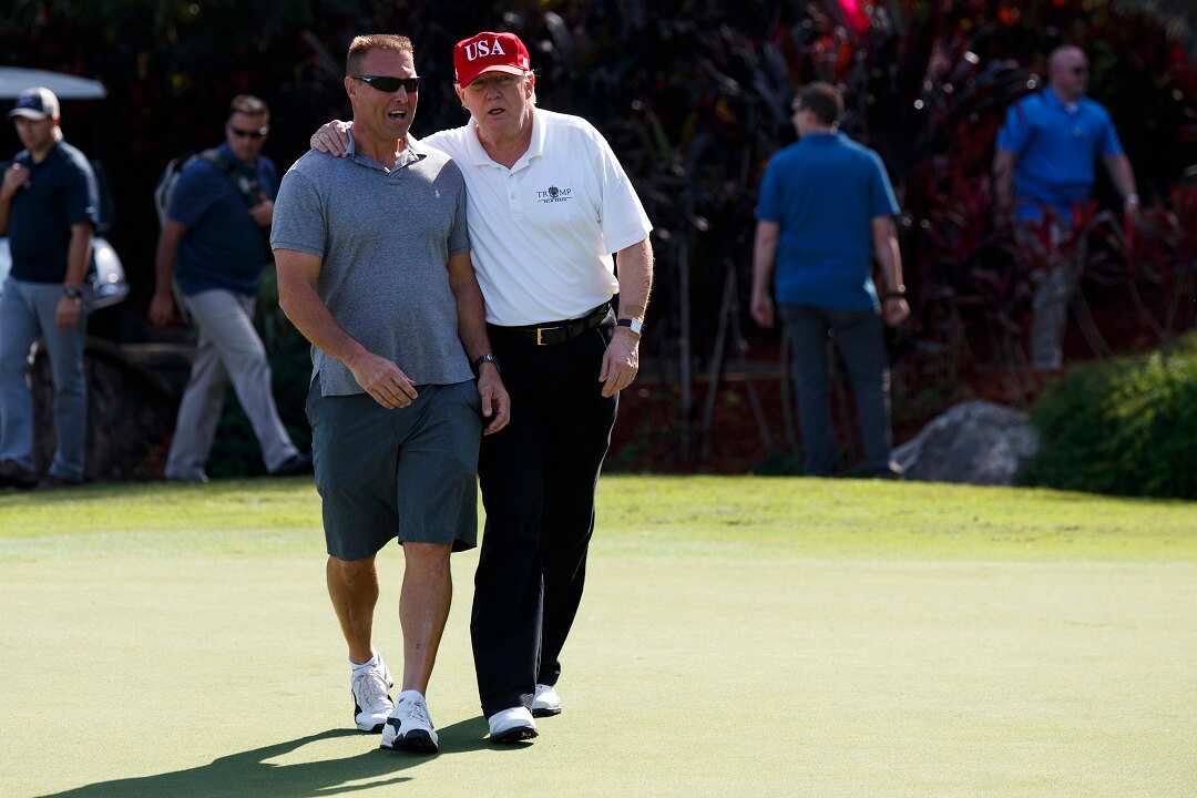 President Donald Trump welcomes Gene Gibson and other members of the Coast Guard to his Trump International Golf Club.