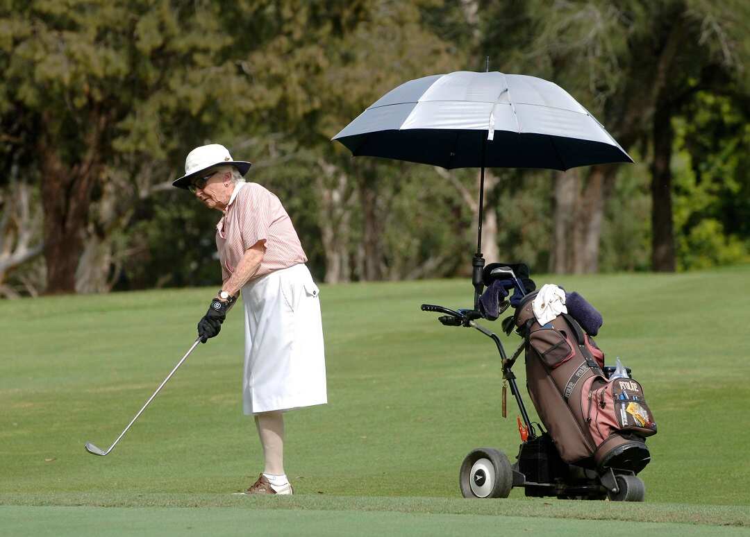 An elderly woman plays a game of golf at a course in Sydney,