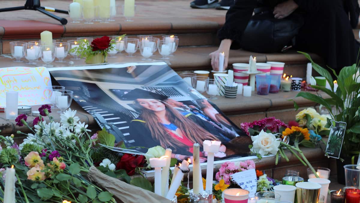 People light candles during a vigil for Grace Millane in Wellington on 12 December 2018. 