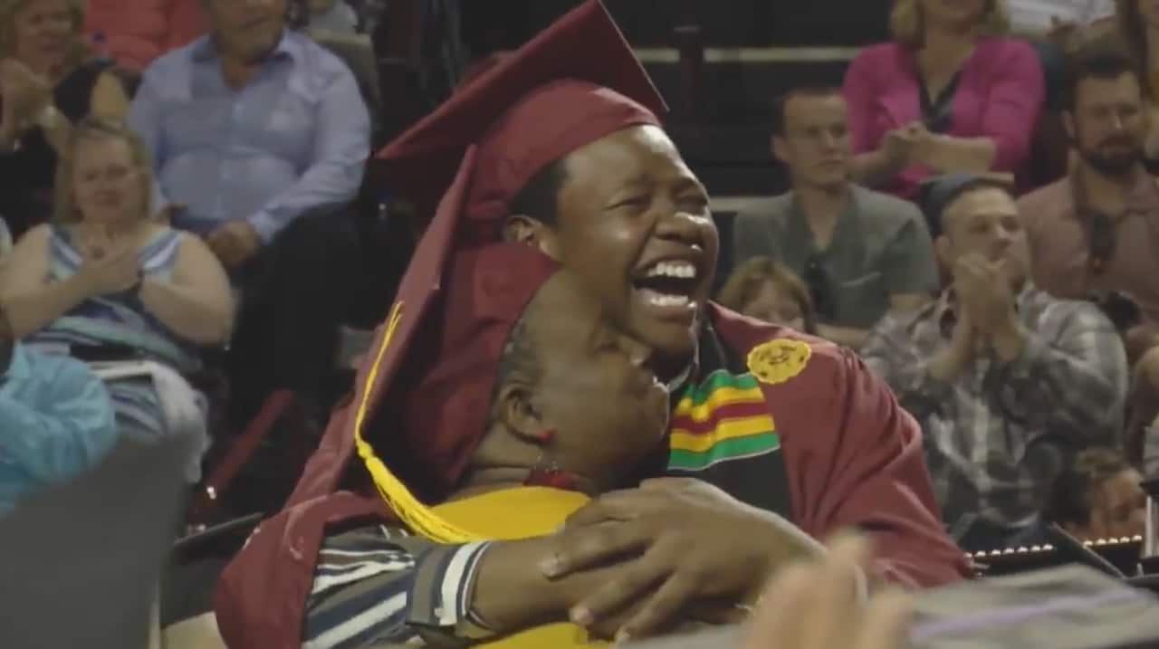 Sharonda and Stephan Wilson embrace as Central Michigan University surprises them with a double graduation.