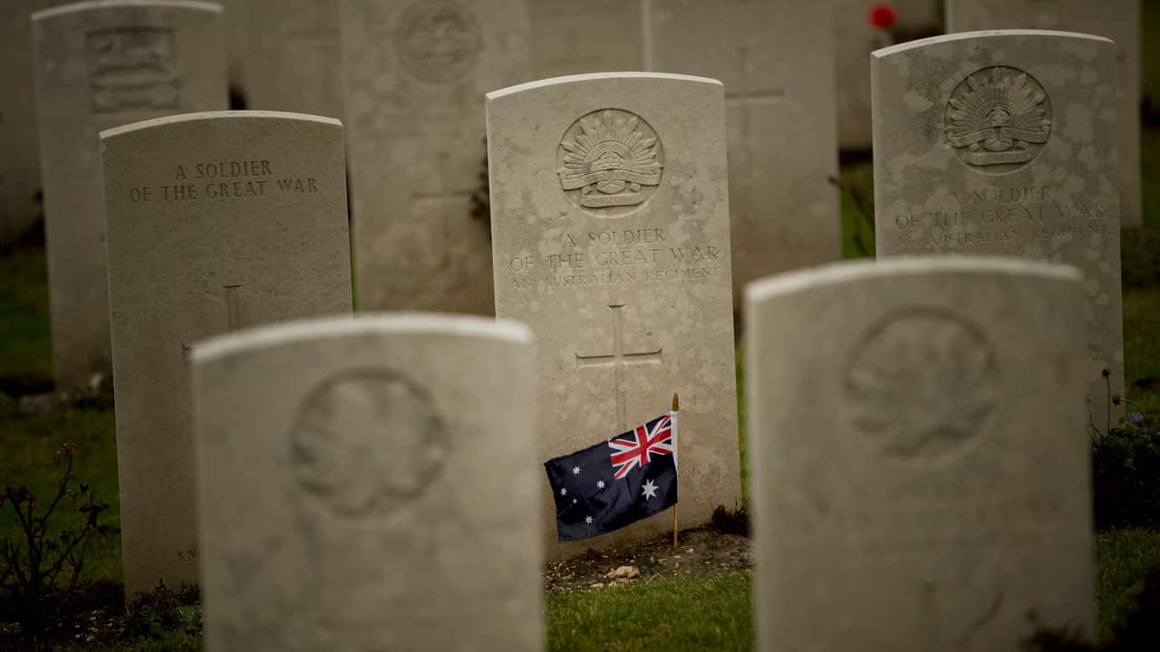 An Australian flag adorns the headstone of an unknown soldier at the World War I Australian National Memorial in Villers-Bretonneux, France.