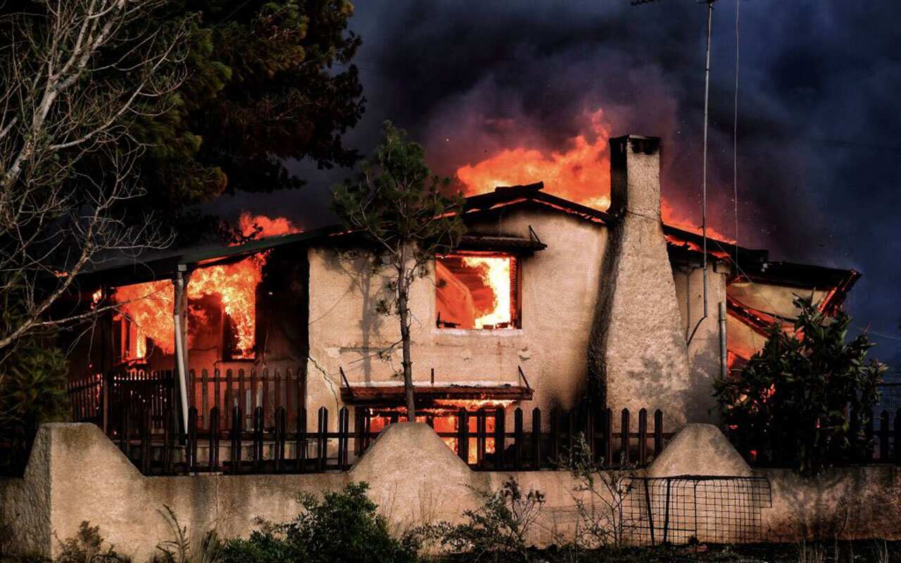 A house burns during a wildfire in Kineta, near Athens, on July 23, 2018.