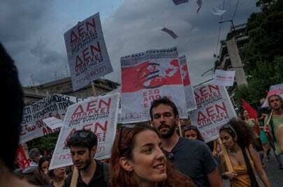 Members of left wing parties hold placards read in Greek ''There is no future in the European Union'' during a protest in Athens, Sunday, June 28, 2015 (AP Photo/Daniel Ochoa de Olza)