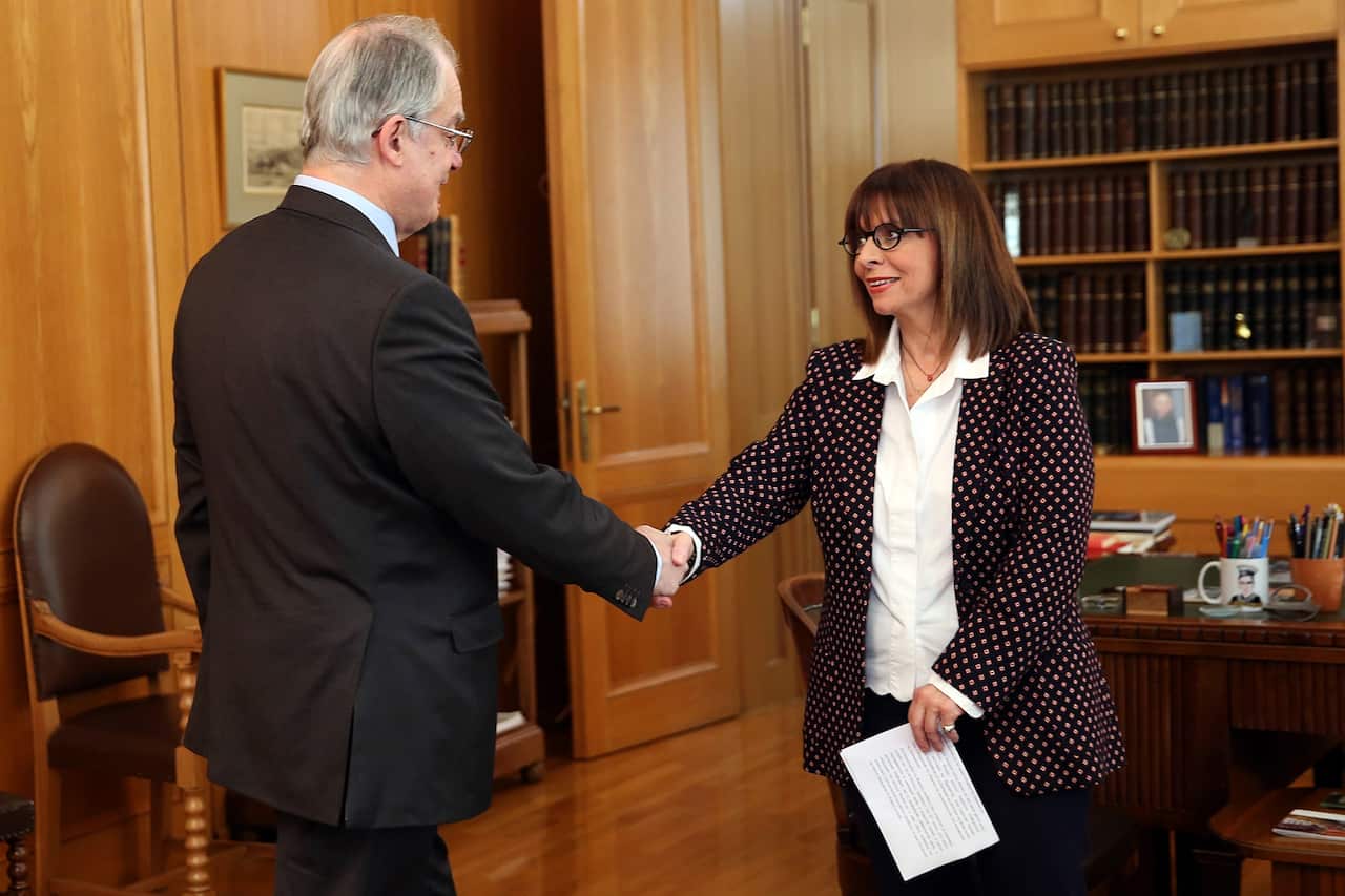  Katerina Sakellaropoulou shakes hands with the Spokesman of the Greek Parliament Konstantinos Tasoulas.
