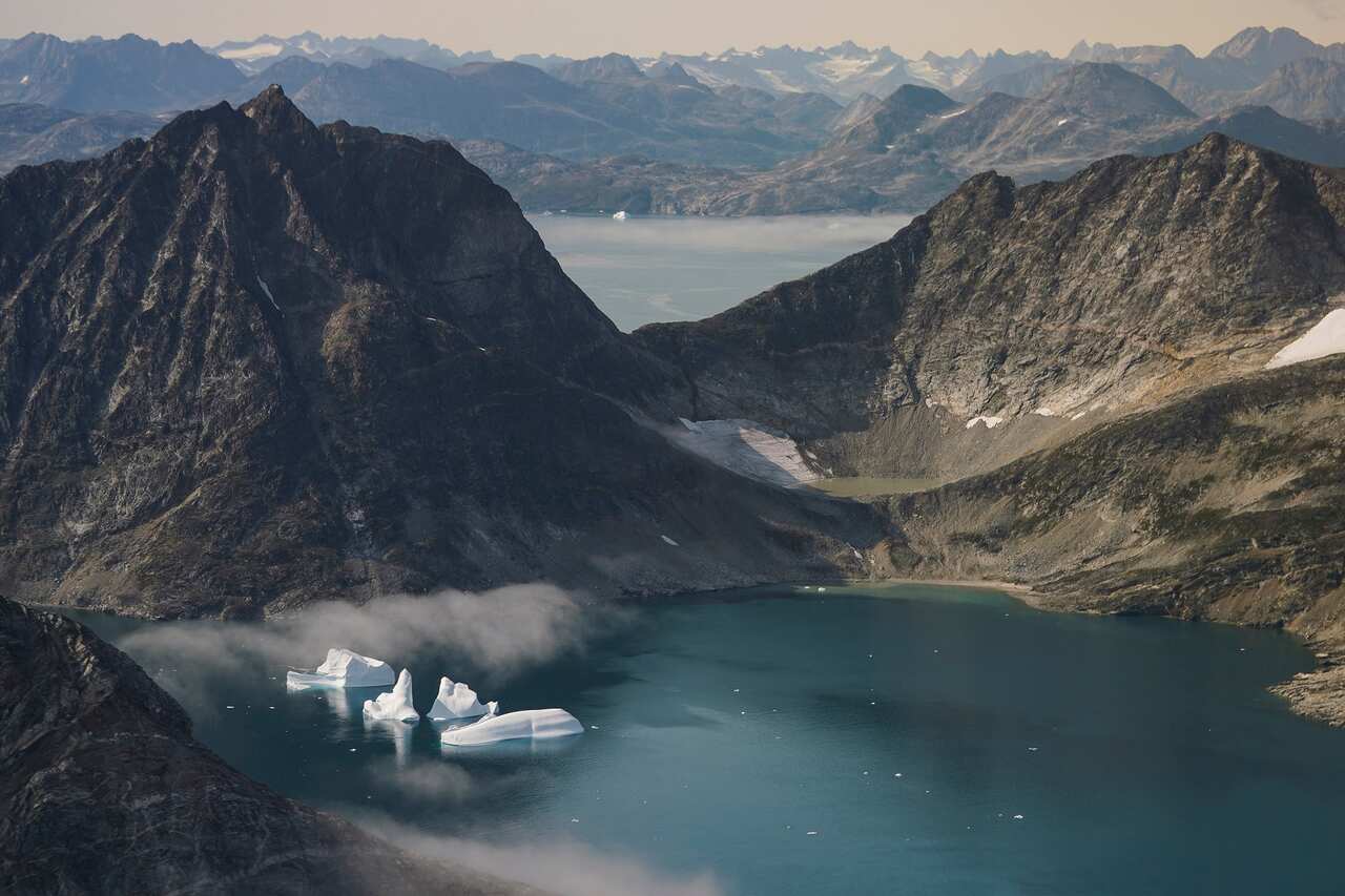 An aerial view of large Icebergs floating as the sun rises near Kulusuk, Greenland on 16 August 2019.