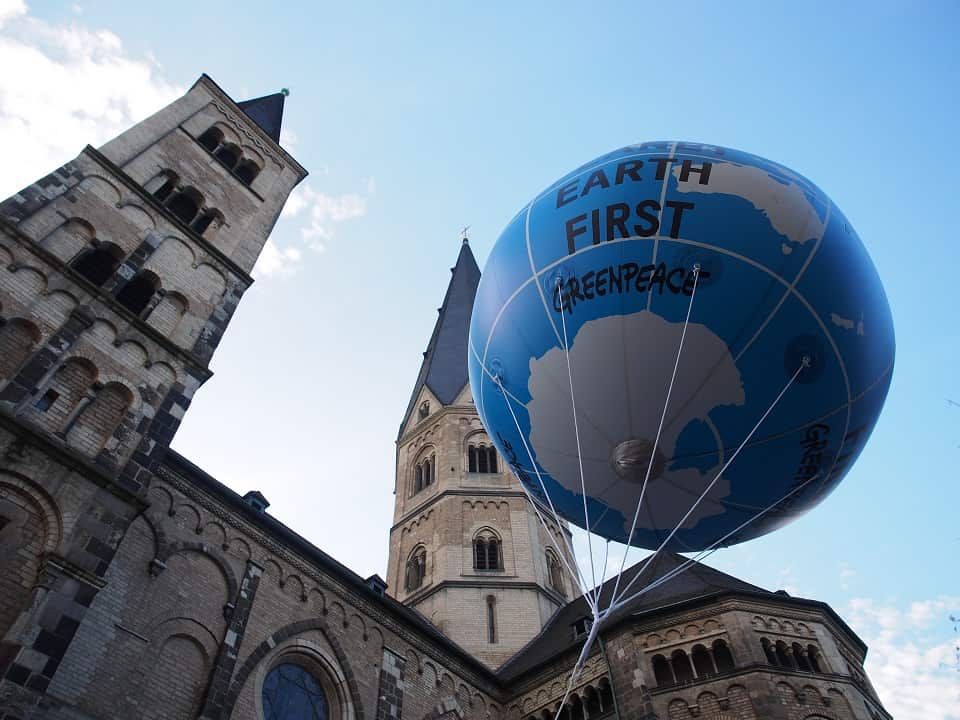 Greenpeace's "Earth First" balloon in Bonn. The organisation is joining the three farmers in the court battle against the government.