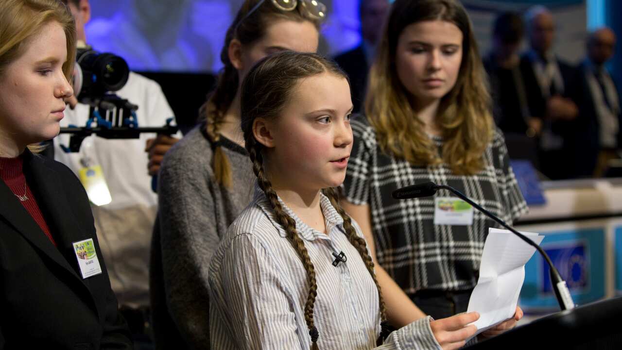Swedish climate activist Greta Thunberg, center, speaks during an event at the EU Charlemagne building in Brussels.