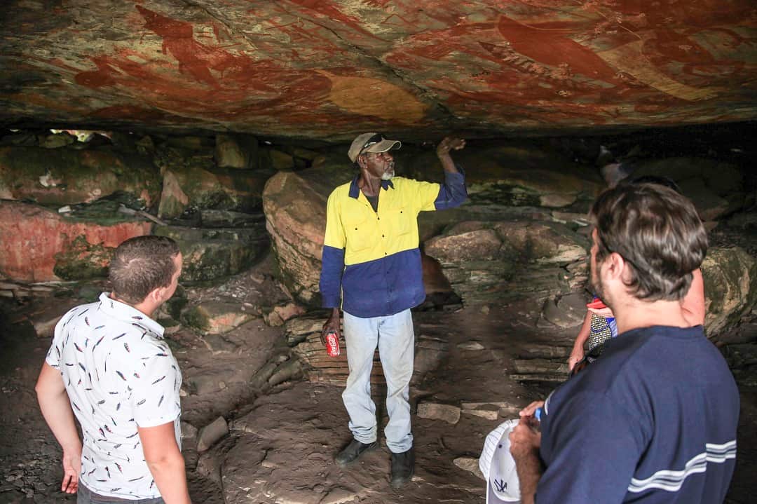 Indigenous man Ronnie explains the cave paintings on Groote Eylandt in the Northern Territory, Tuesday, April 5, 2016. The island is aiming to boost its profile as a boutique holiday destination. (AAP Image/Stephanie Flack) NO ARCHIVING