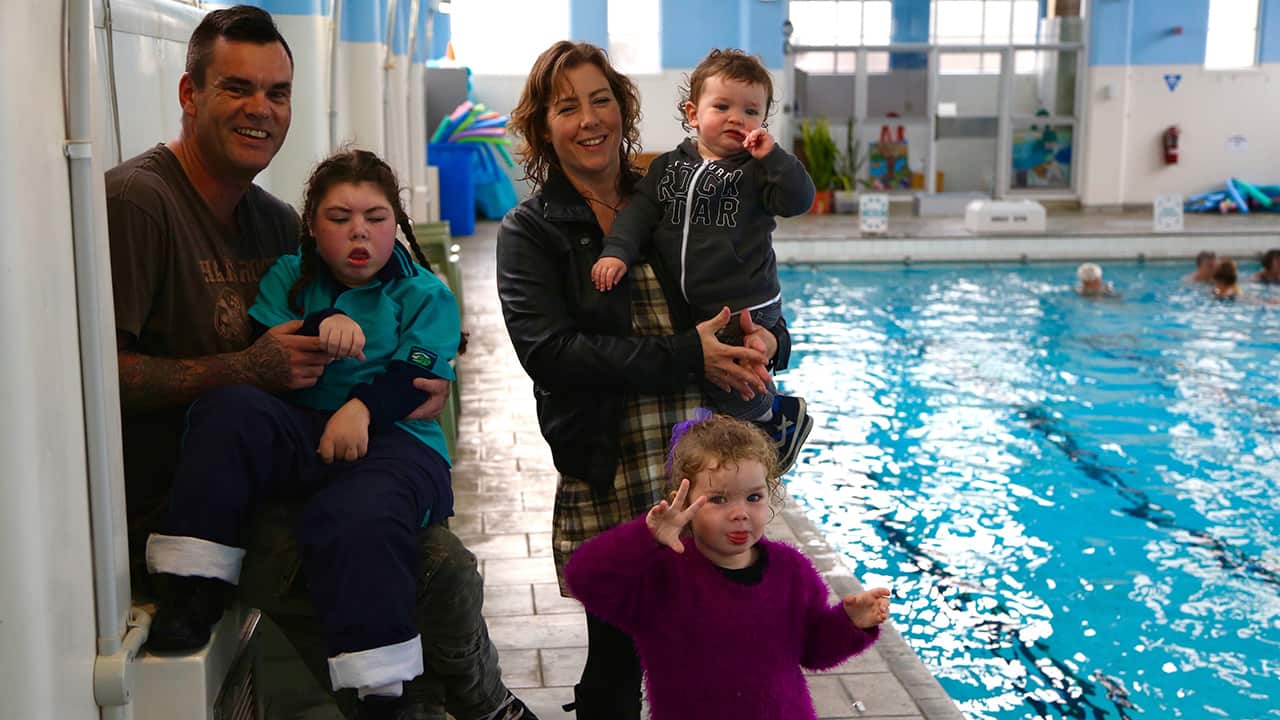 Janine and her partner Rob at the swimming pool with Daryl-Ann and their two younger children Georgia and Drayven.