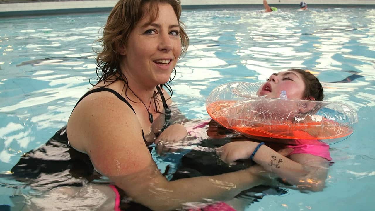 Janine says Daryl-Ann can be weightless and relax in the pool away from her equipment, and that would be much more difficult if she grew larger.