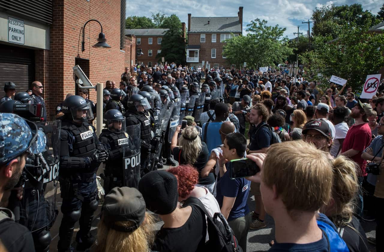 Riot police barricade the entrance to a parking garage the Ku Klux Klan was preparing to leave on July 8, 2017 (Getty)