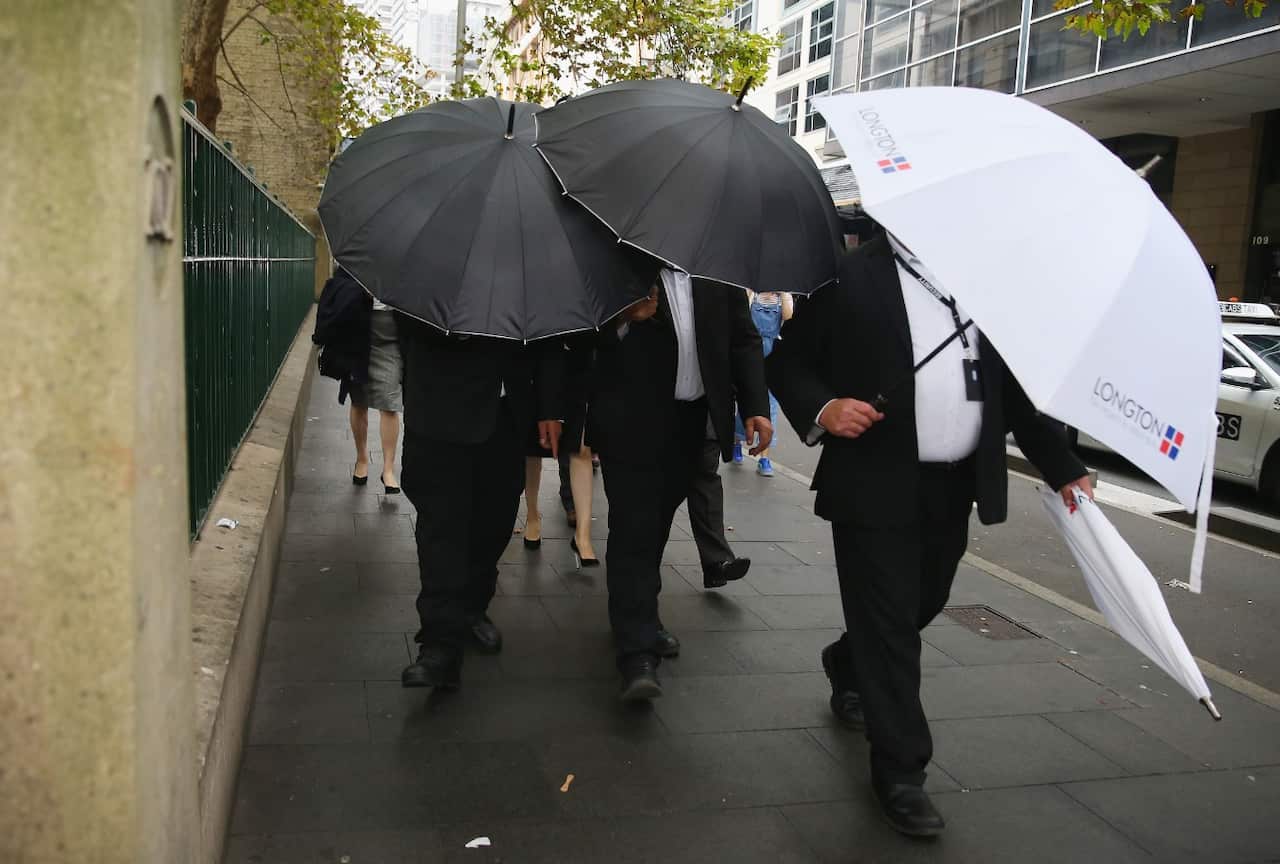 Bodyguards surround Yunxiang Gao as he arrives at court on April 10, 2018 in Sydney, Australia.