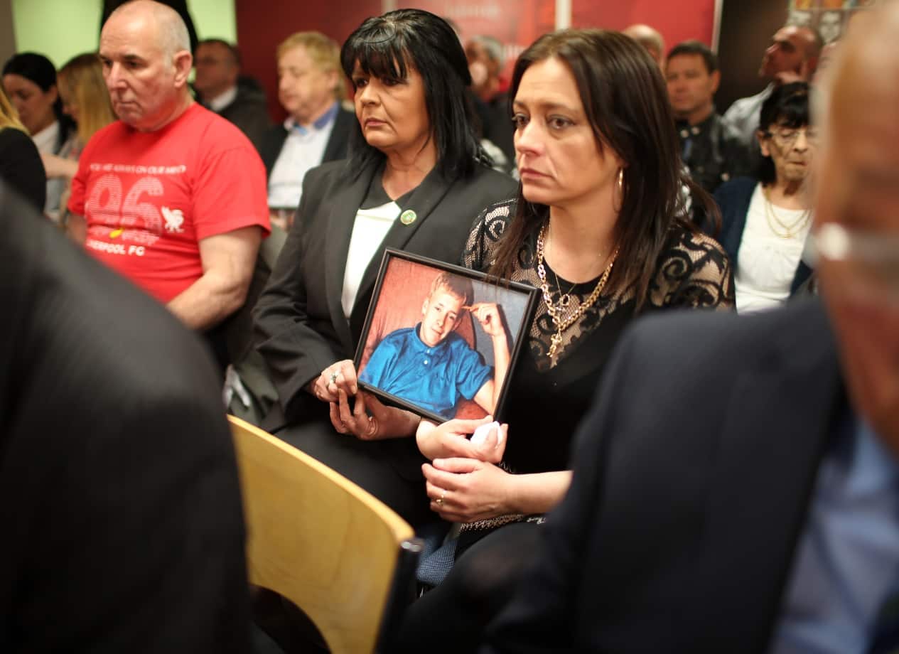 Family members hold photographs of loved ones who died in the Hillsborough disaster during a Hillsborough Justice Campaign event (Getty)