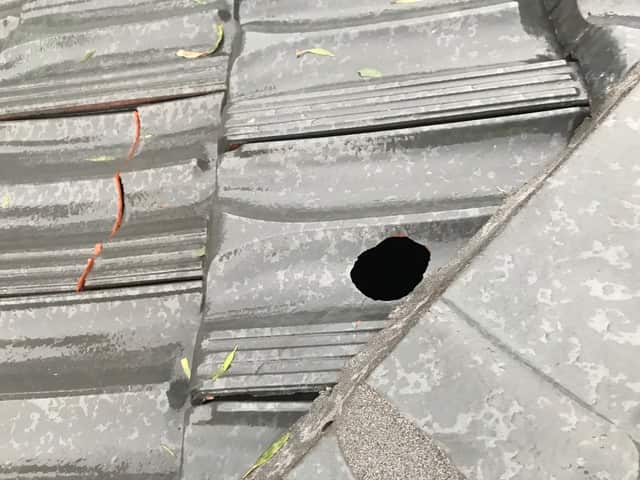 Large hail stones can cause clean-cut holes in tiles, like this damaged roof in Melbourne.