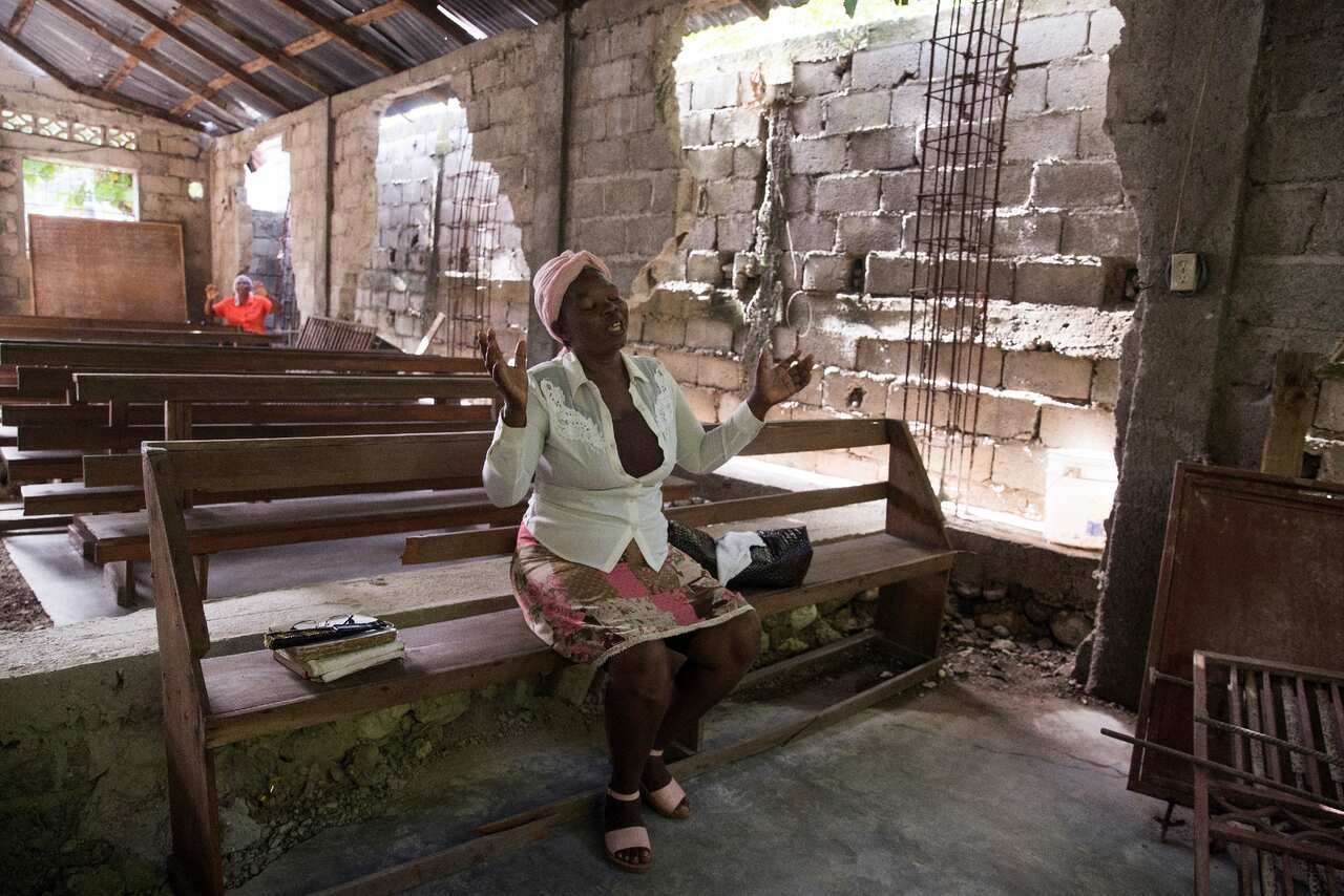 People attend an evangelical church at the outskirts of Les Cayes in Haiti on 22 August 2021. 