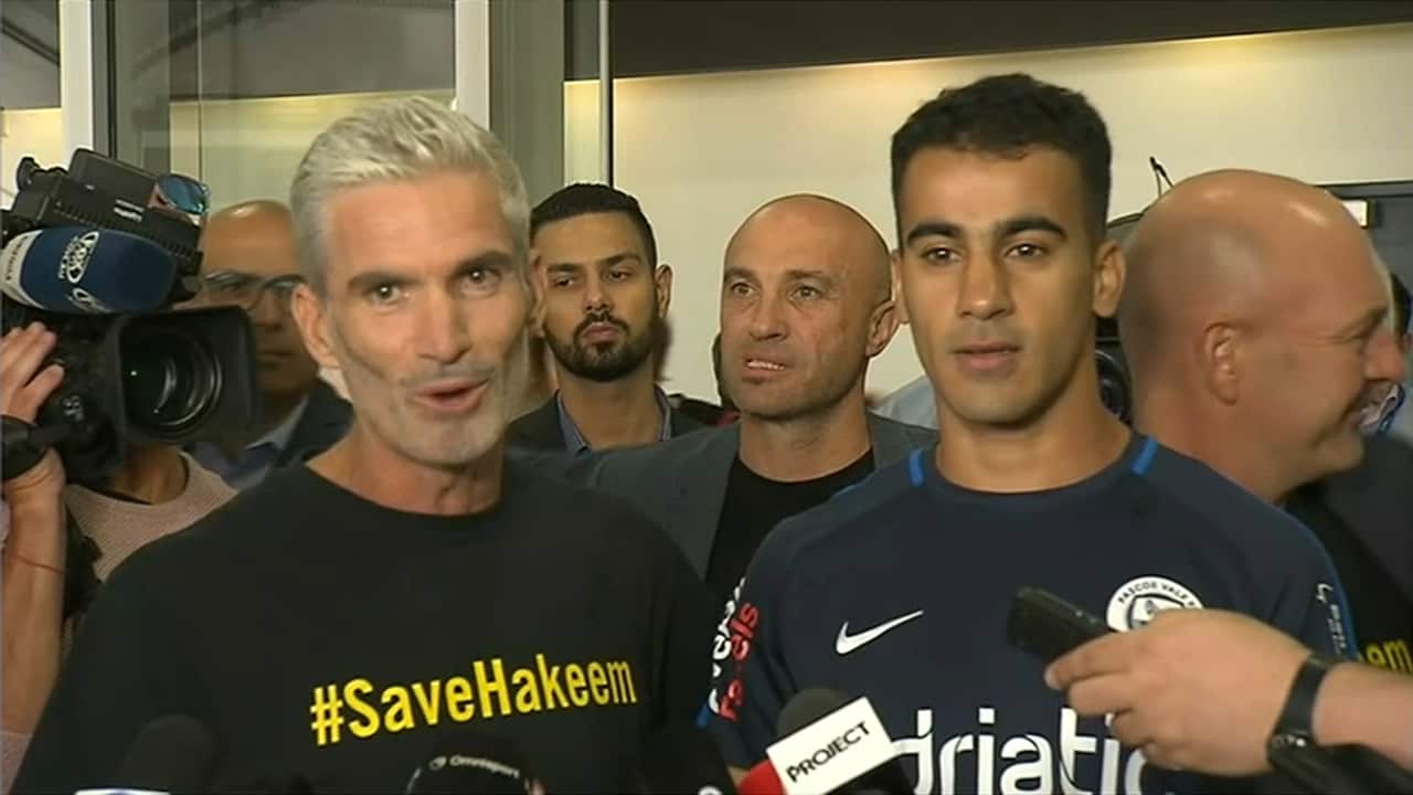 Craig Foster and Hakeem Al-Araibi speak to reporters after the footballer's arrival in Melbourne.