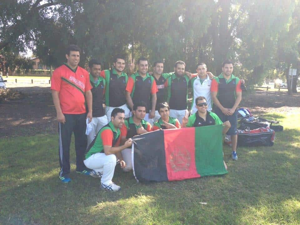 Proud of his heritage...Flying the Afghan Flag at a community cricket carnival. (Supplied)