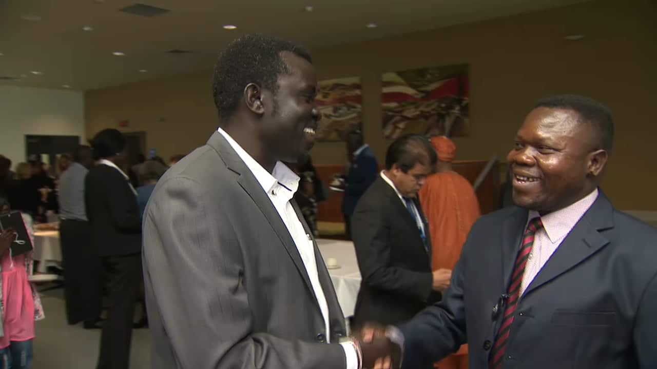 Juma Piri Piri meets and greets community leaders during the conference break.