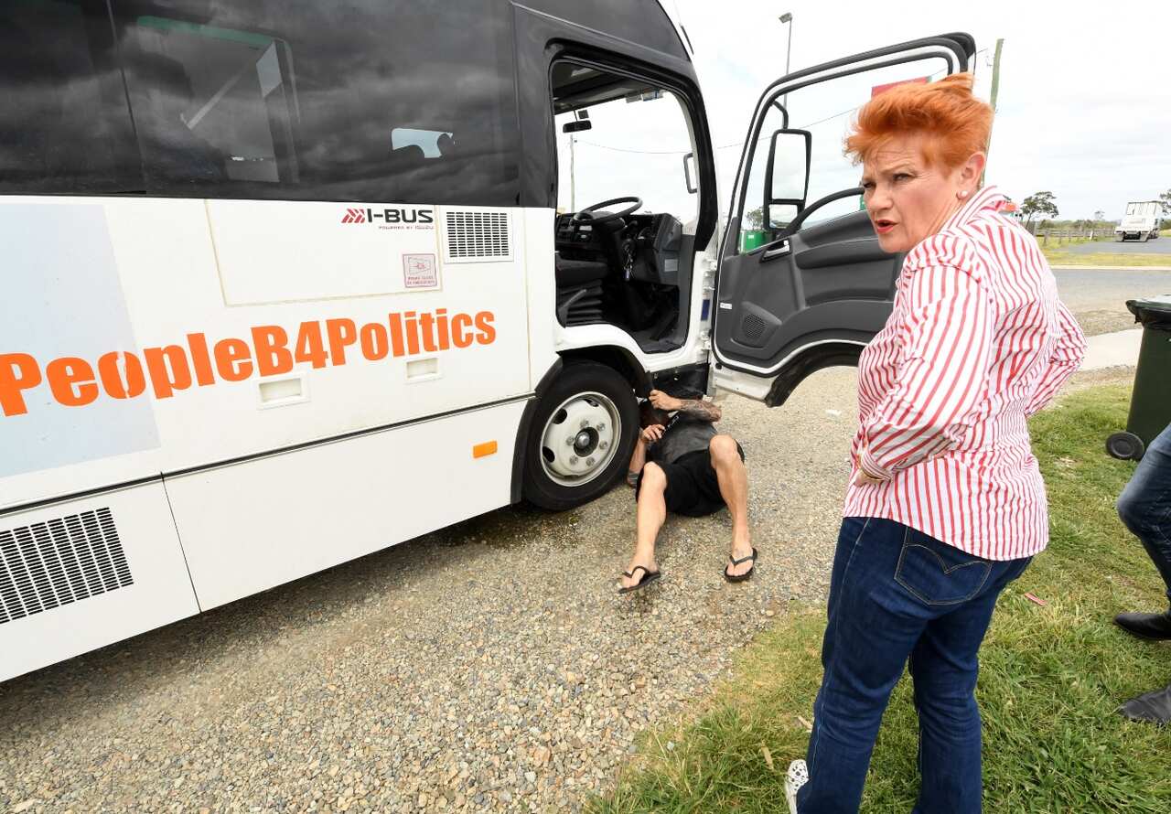 One Nation leader Pauline Hanson looks on as a truck driver stops to inspect the 'Battler Bus' after a break down in Marlborough (AAP)