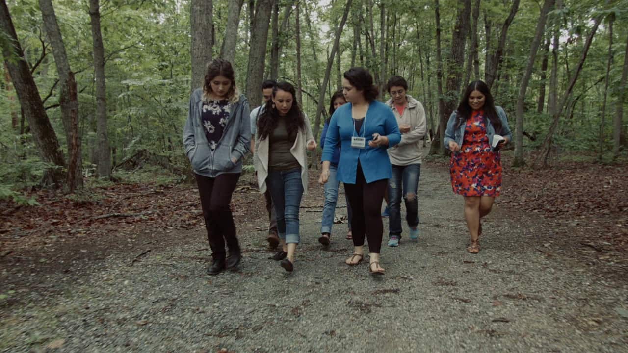 Nadia Moreno (centre in blue) is one of those taking part in a training camp on protecting the rights of farmworkers like her parents. 