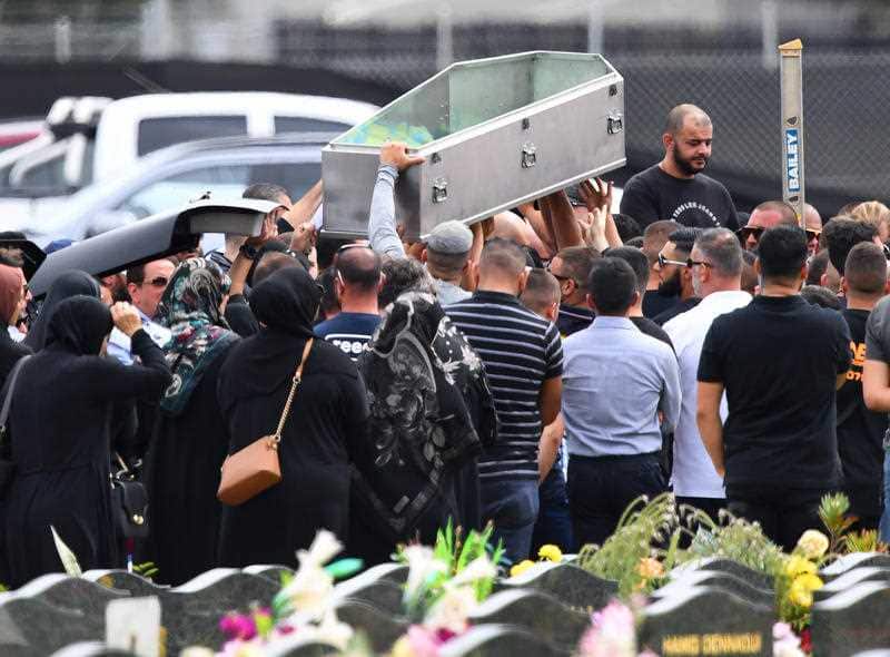 Mourners carry Hawi's coffin during his funeral.