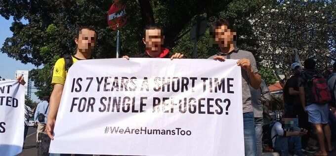 Mr Akbari (centre) protested outside the UNHCR office in Indonesia in 2018 after waiting years to be resettled in a country as a refugee.