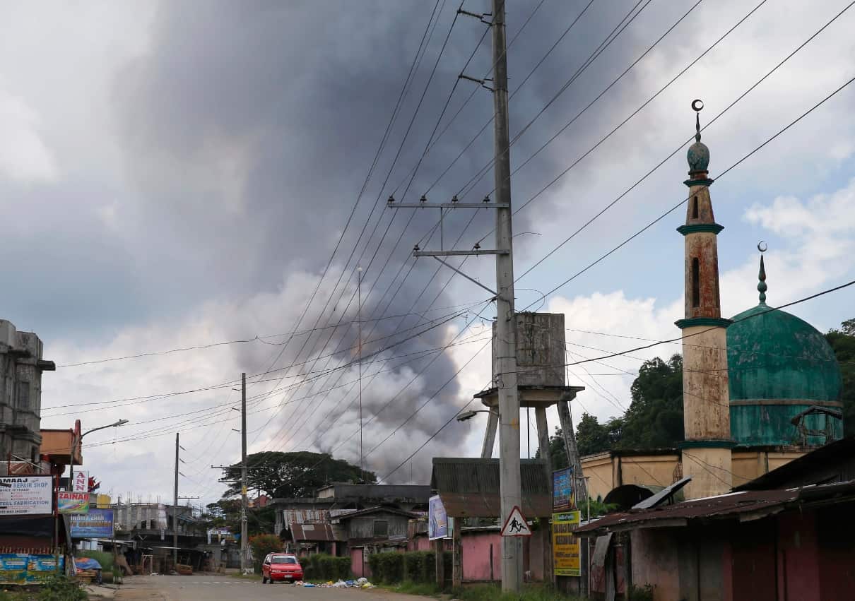 Some rises from houses following airstrikes by Philippine Air Force bombers in Marawi, southern Philippines, Saturday, May 27, 2017. (AAP)